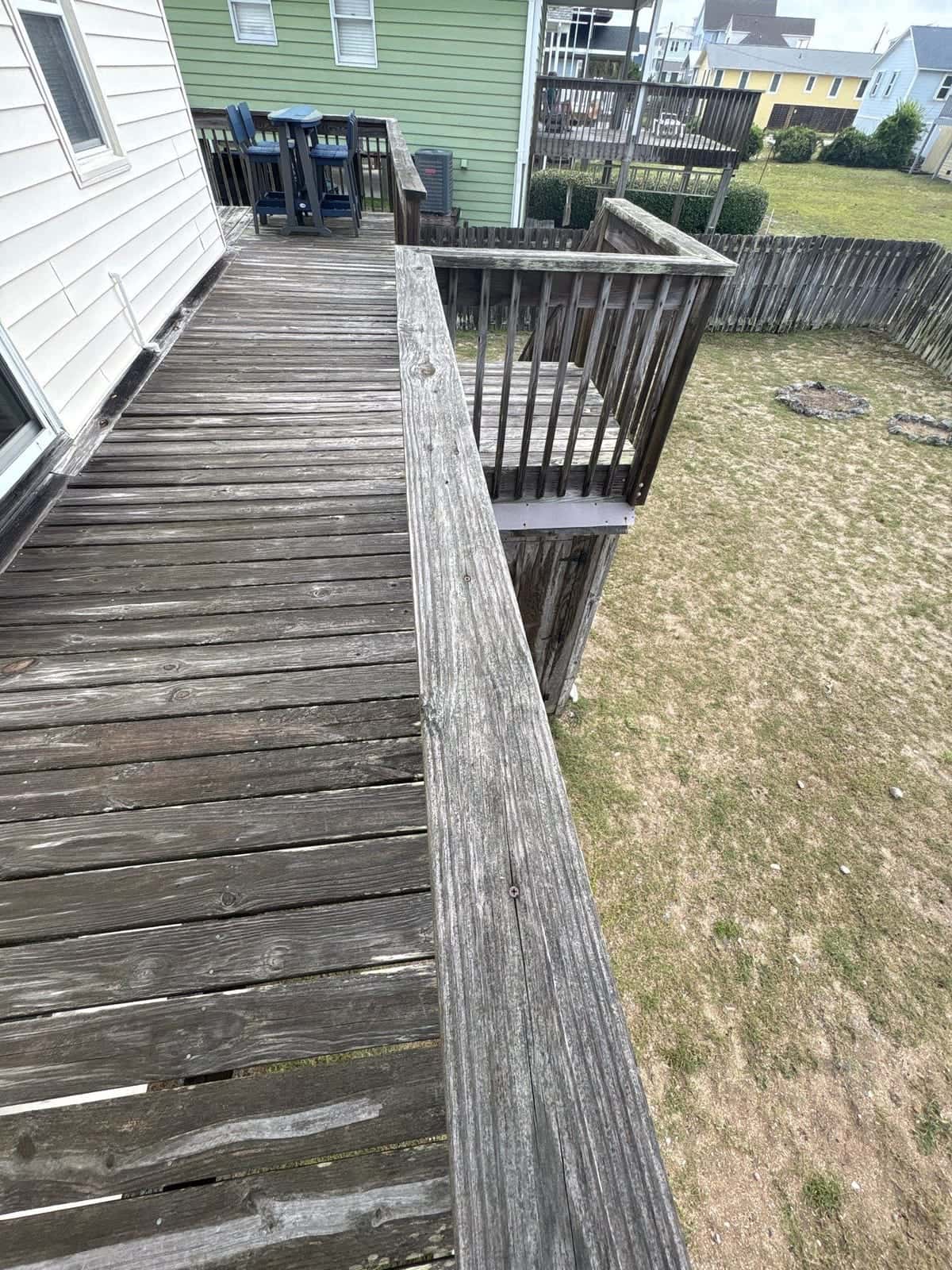 Before: Wood deck cleaning before and after in the Wilmington, NC area: gray weathering and buildup removed from deck boards and railings