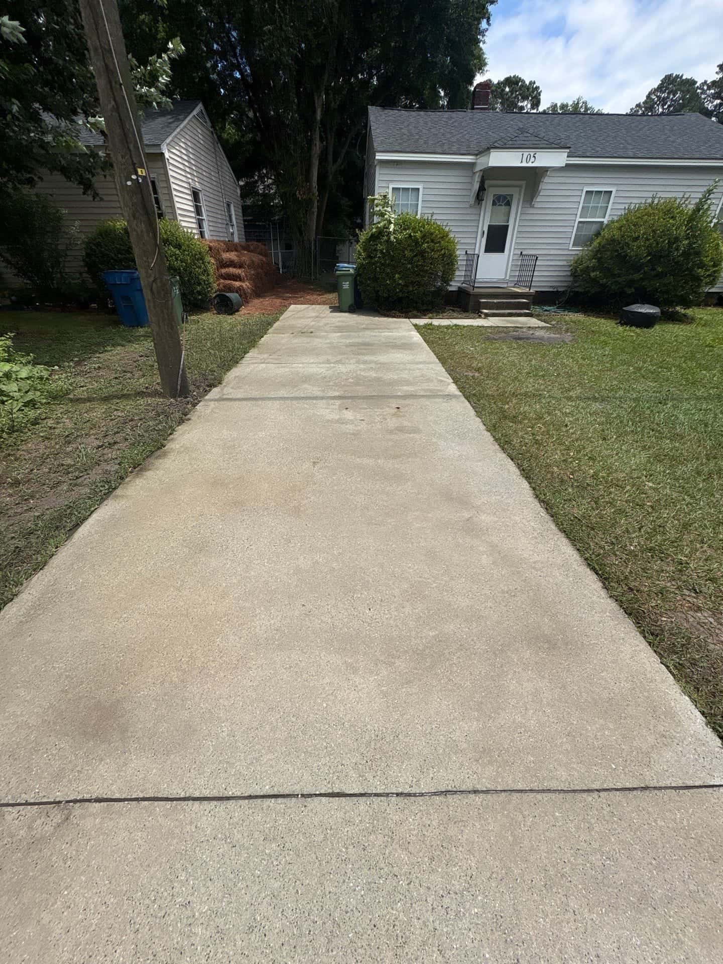 After: Concrete driveway cleaning before and after in the Wilmington, NC area: dark stains and mold lifted from concrete